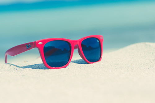 Red sunglasses on a sunny beach